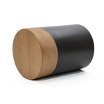A versatile decorative side table with a cylindrical design features a wooden top and a sleek black body, elegantly lying on its side against a white background.