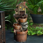 a-small-fountain-with-a-house-and-birds