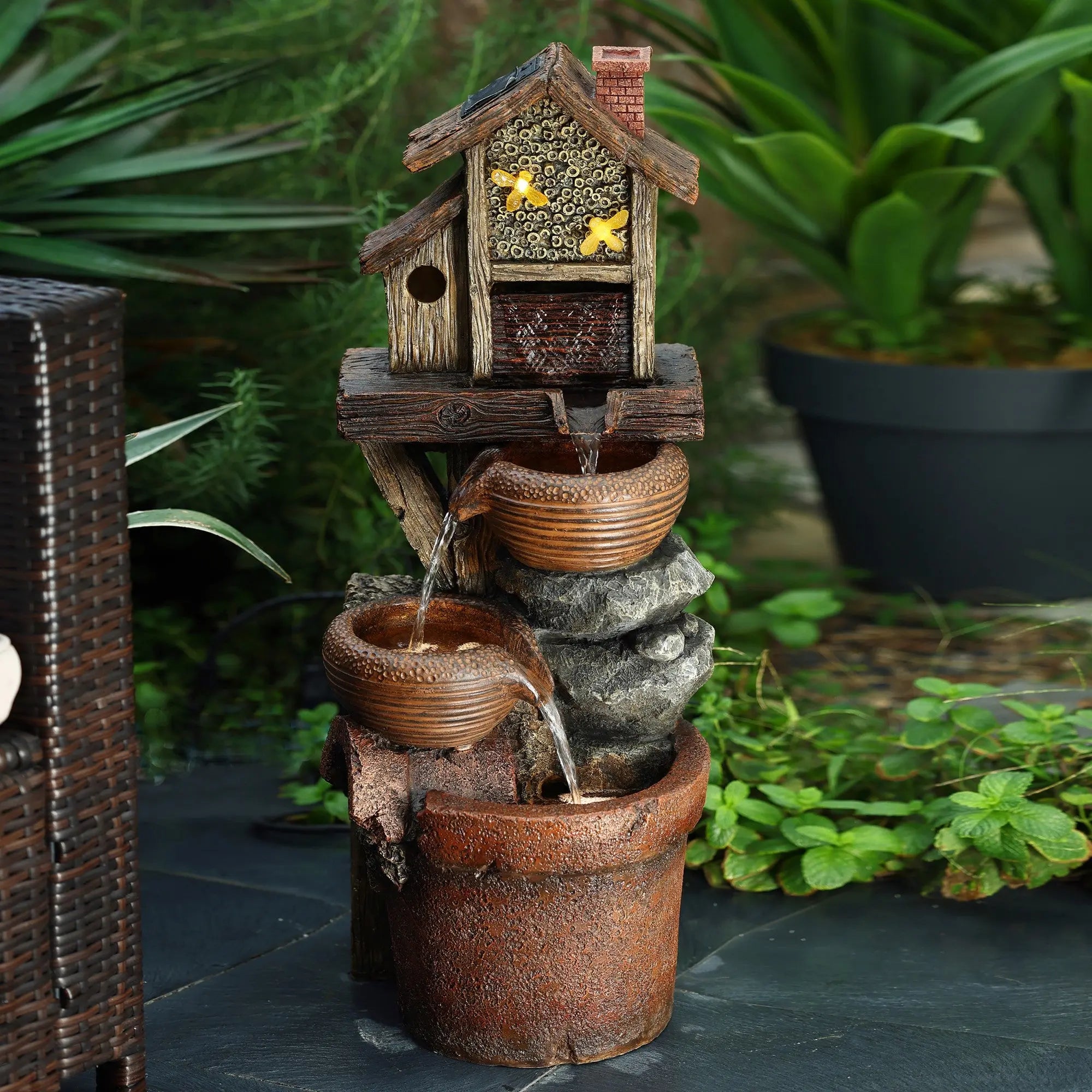 a-small-fountain-with-a-house-and-birds