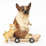 A durable resin sculpture featuring a French bulldog statue sits on a skateboard with a small cat standing beside it, perfect for eclectic style decor.