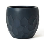 Dark gray stone planter crafted from magnesium oxide material, featuring a striking geometric pattern around its middle section. Perfect for both indoor and outdoor use.