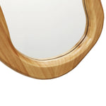 Close-up of a wooden-framed mirror with an organic decor vibe against a white background, highlighting the graceful curve of the natural pine frame.