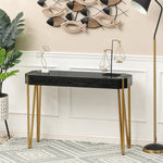 A modern black console table with metal hairpin legs sits against a wall, decorated with metal sculptures and positioned beside a floor lamp and green plant.