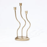 An elegant candle holder with three wavy, vertical stems rises gracefully from the round base, embodying a sophisticated touch of home decor artistry against a white background.