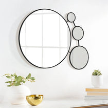 round-mirror-and-a-vase-on-a-table