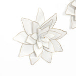 A stunning example of metallic art, this white decorative flower with gold edges stands out beautifully against a plain background.