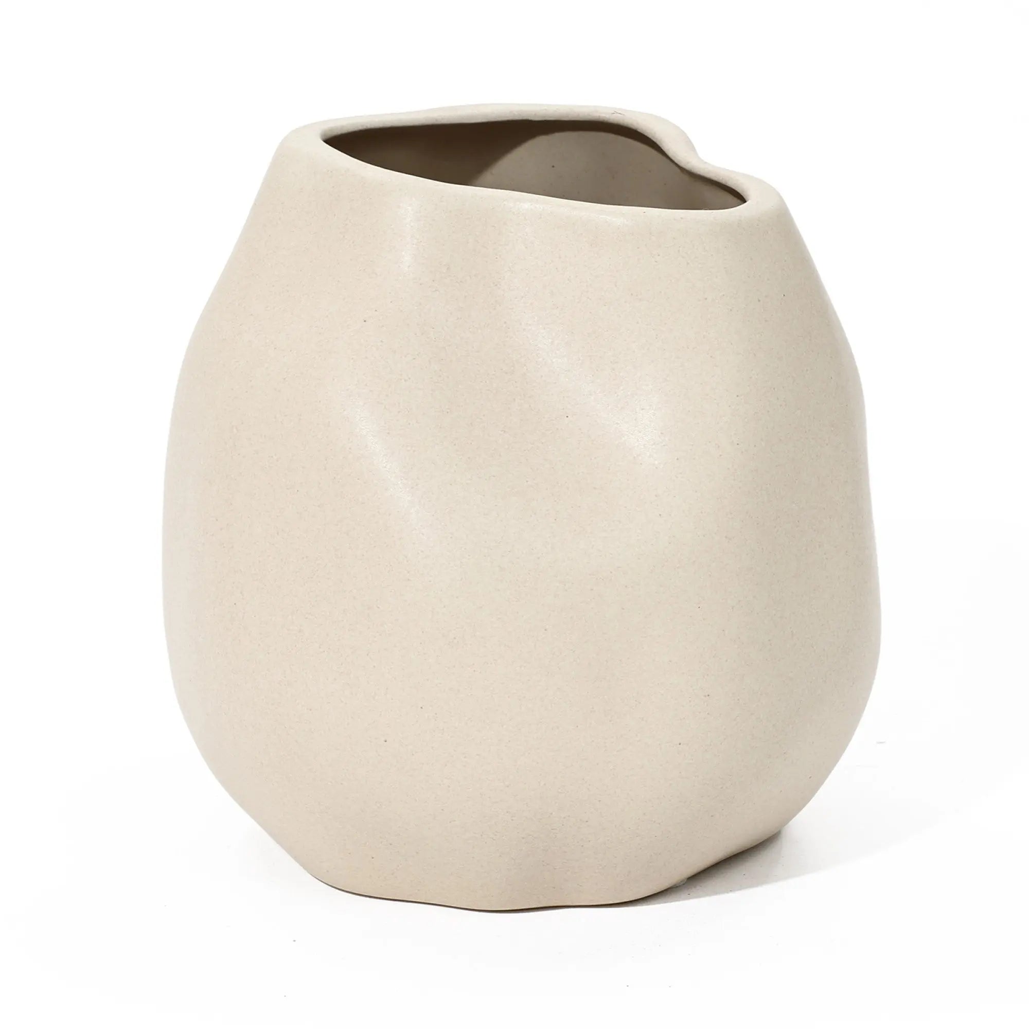 This ceramic vase, ivory white and irregularly shaped, features a smooth surface with a wide, uneven opening, making it a perfect accent piece for any room.