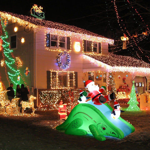Santa and Penguins Trio Sliding on a Dinosaur Inflatable Holiday Decoration