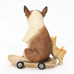 Two dog figurines sit on a wheeled wooden base, facing away. The larger French bulldog statue appears to be a bulldog, and the smaller dog stands closely beside it. Perfect for eclectic style decor, this pair adds charm and character to any space.