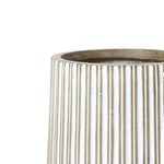 Close-up of a beige, vertically ribbed magnesium oxide planter with a smooth, rounded opening.
