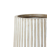 Close-up of a beige, vertically ribbed magnesium oxide planter with a smooth, rounded opening.