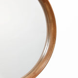 Close-up view of a wooden round wall mirror with a natural wood finish against a white background.