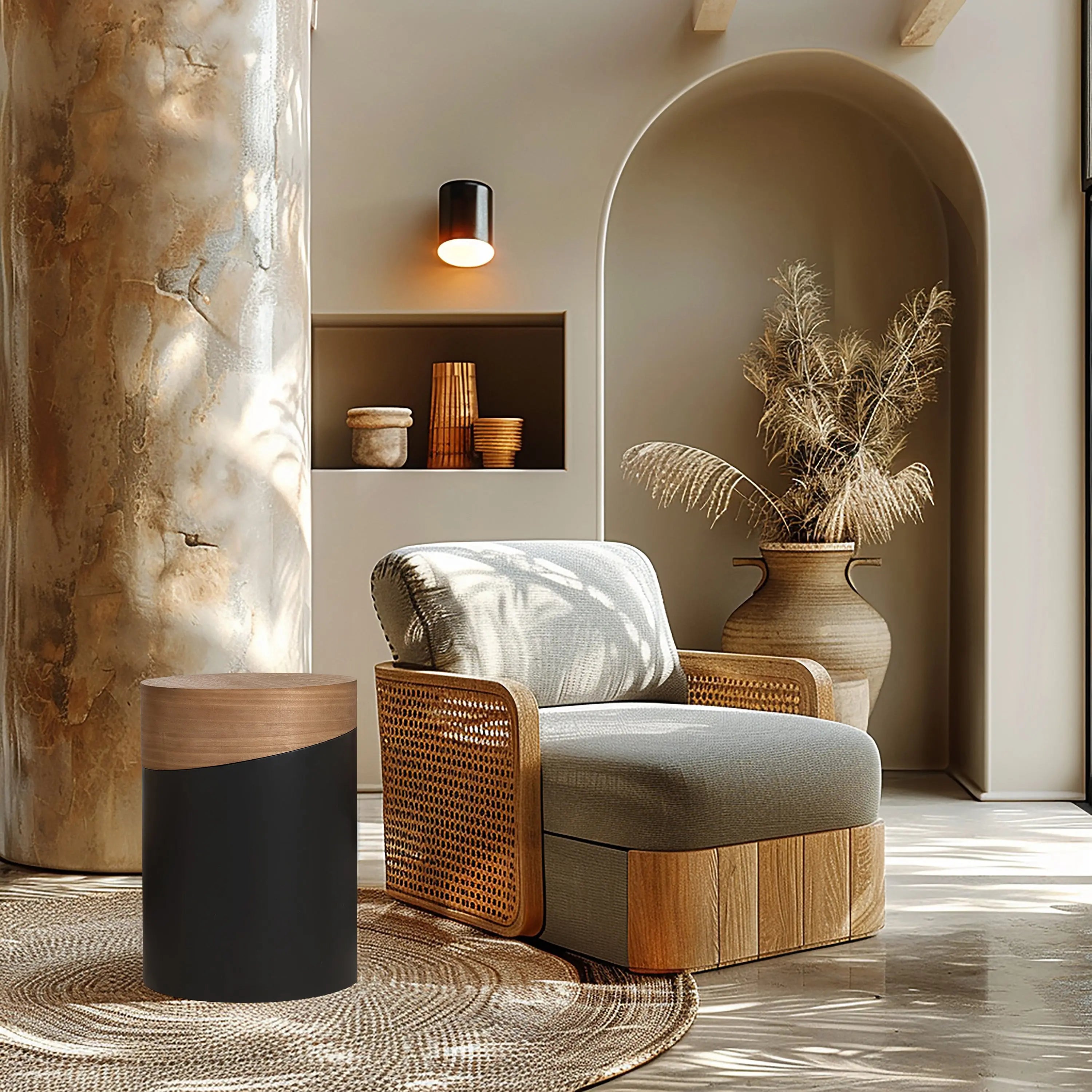 A modern living room with a wooden armchair, a decorative side table featuring a wooden top, woven rug, a large vase with dried grasses, and a wall sconce. This versatile piece complements the neutral tones and natural textures of the decor.