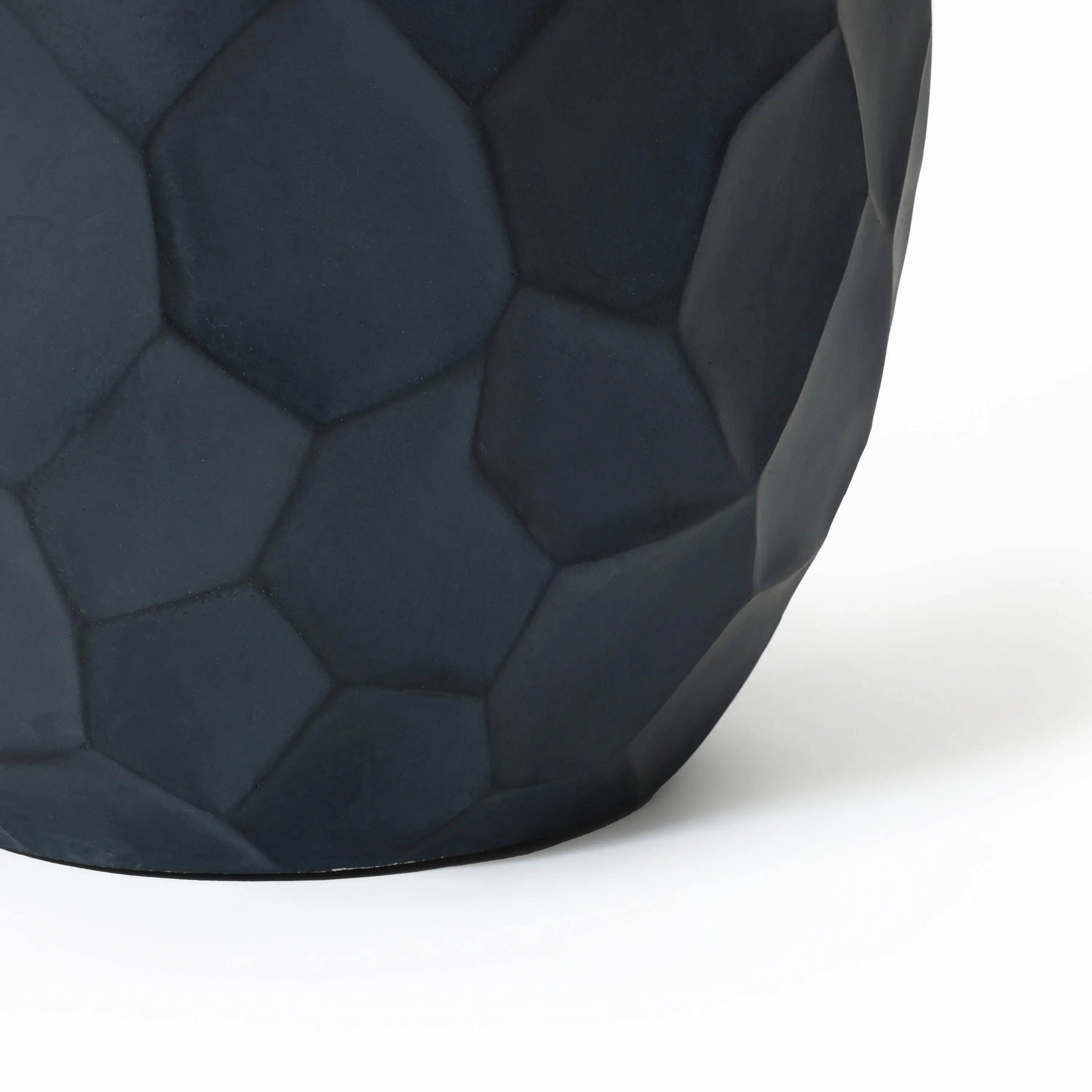 Close-up of a dark, hexagonal-patterned geometric pot planter crafted from magnesium oxide material, suitable for both indoor and outdoor use, on a white background.