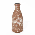 A tall, round ceramic vase exuding rustic charm features a textured white pattern, showcasing its handcrafted earthenware elegance.