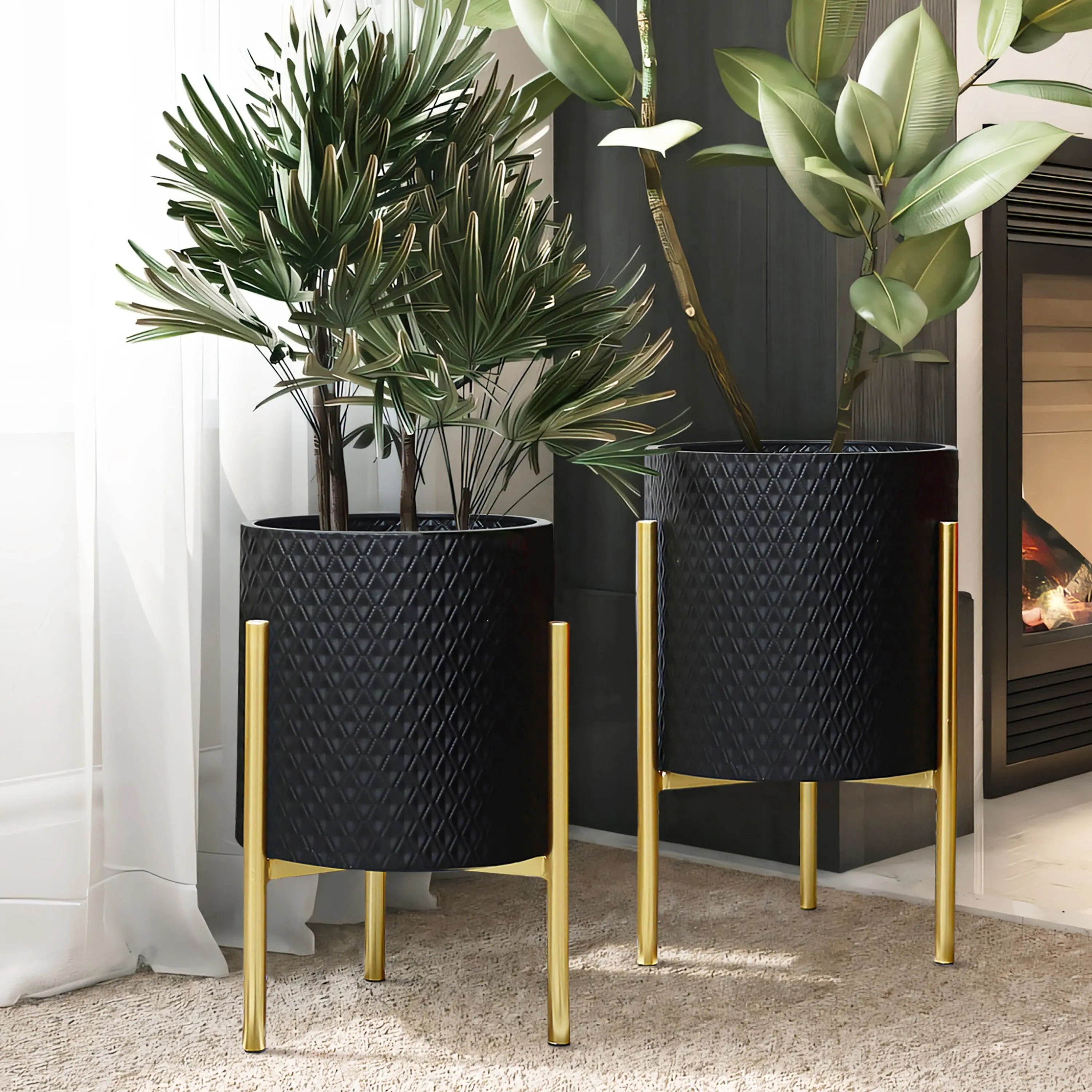 Two contemporary modern style planters with gold stands hold leafy green plants, strategically placed near a fireplace and curtain in a well-lit room. These durable iron planters add a touch of elegance to the space.