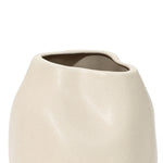Ivory white ceramic vase featuring an asymmetrical, wavy rim and smooth surface, perfect as a striking accent piece.