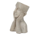A stone-colored bust planter shaped like a head and upper torso, with the face resting on both hands and the top of the head open for planting—an eye-catching decorative statue for any space.