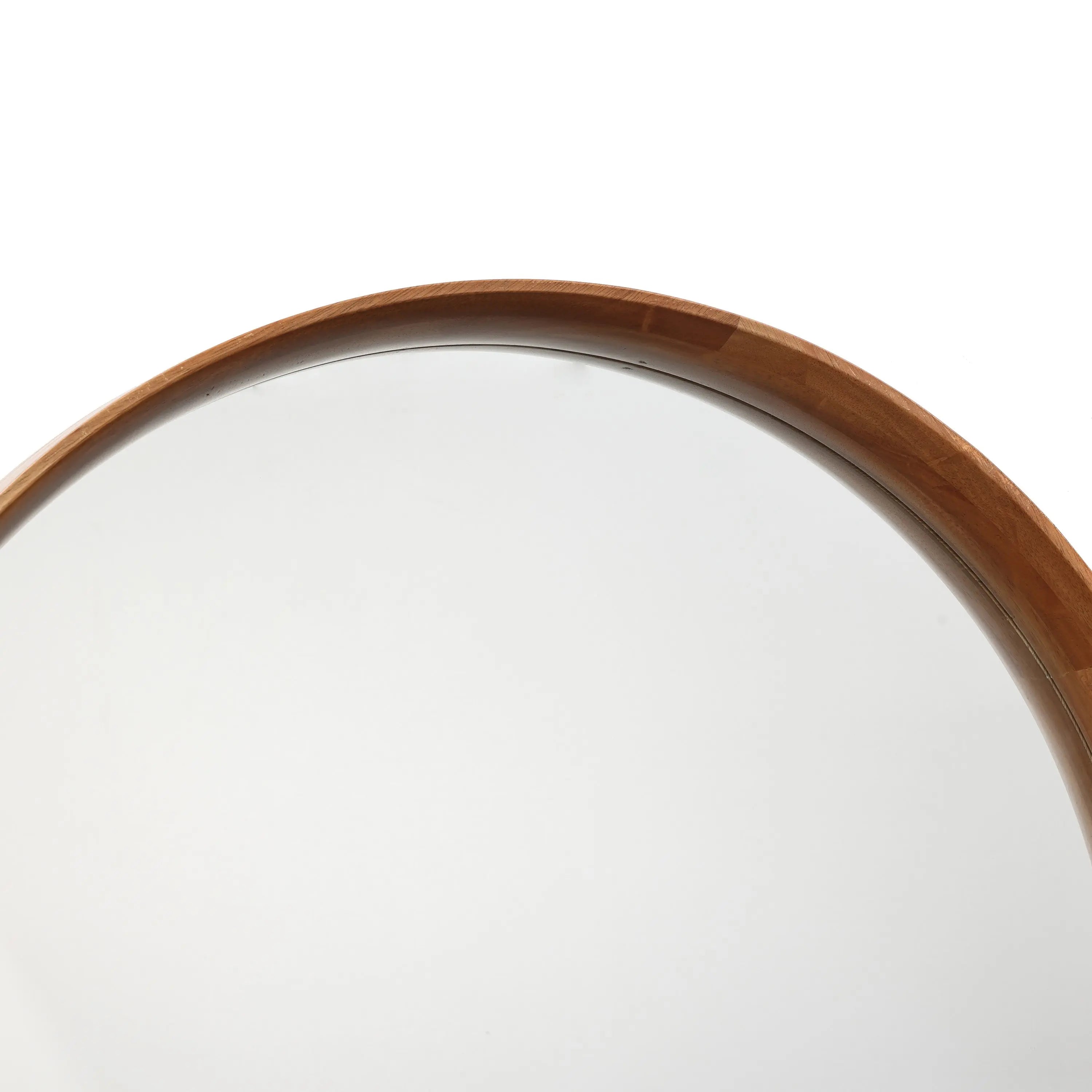 A beautifully crafted wooden round wall mirror with a natural wood finish reflects a pristine white background, adding a touch of elegance to any space.