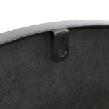 Close-up of a black metal pan with an artistic design, featuring a hanging loop on the side.