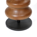 A close-up reveals a wooden object crafted from birch, showcasing smooth, curved shapes on a round, black base against a white background. This elegant piece doubles as a striking candle holder and effortlessly enhances any home decor setting.
