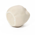 Ivory white ceramic vase with a smooth, curvy surface and three small white pads on the base, perfect as an accent piece in any space.