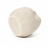 Ivory white ceramic vase with a smooth, curvy surface and three small white pads on the base, perfect as an accent piece in any space.