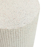 Close-up of a textured cylindrical surface reminiscent of an ivory white side table with vertical grooves and a speckled pattern in shades of beige, black, and pink.