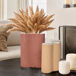 vase-and-two-cylindrical-candles-on-a-table