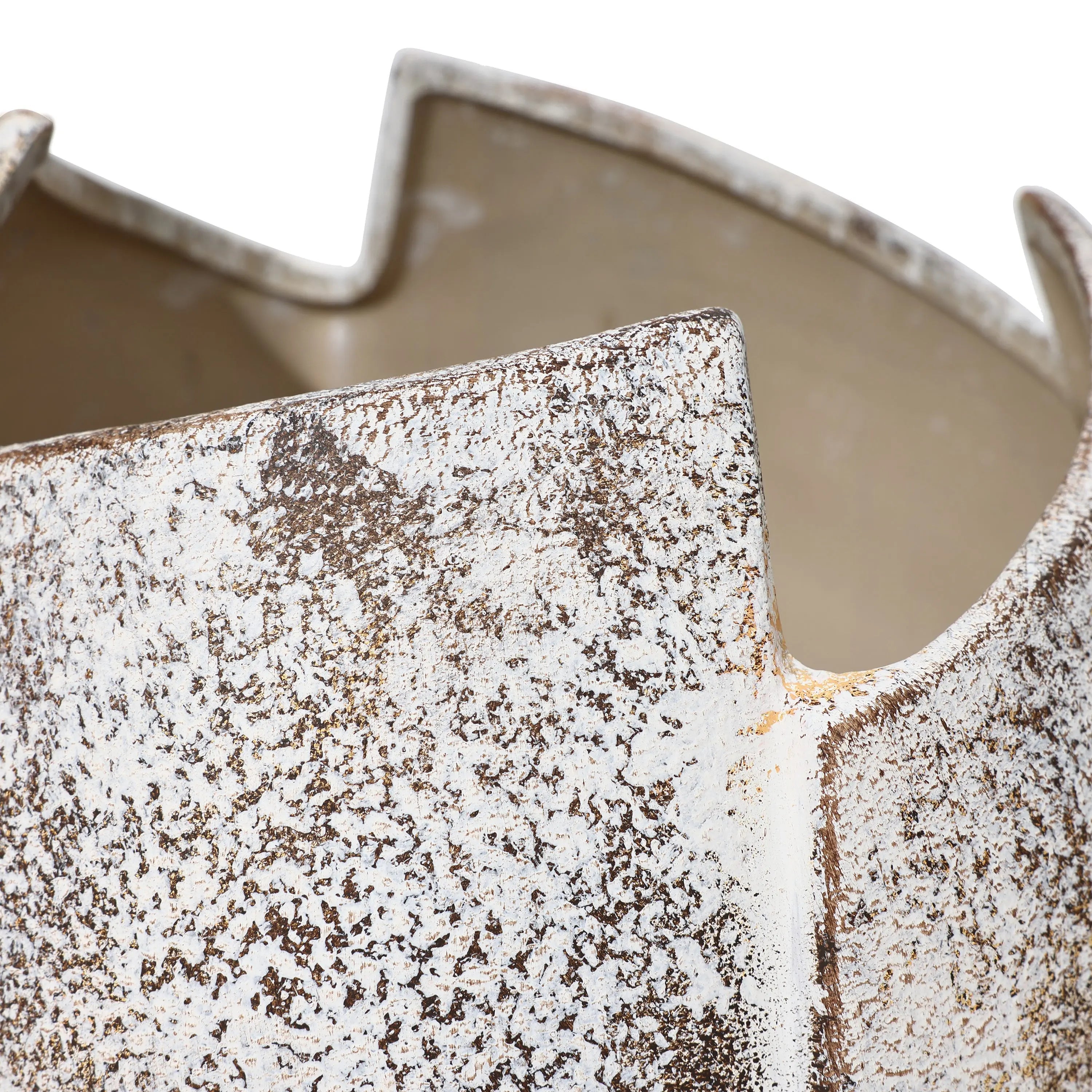 Close-up of a ceramic vase with a textured, speckled surface and irregular, jagged edges, reminiscent of a broken egg design.