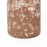 Close-up of a tall round ceramic vase with a textured surface in rusty brown and white, displaying a speckled pattern that exudes rustic charm.