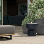 black-cement-bubbling-water-fountain-in-modern-backyard-by-the-side-of-planters
