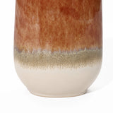 Close-up of a vintage ceramic vase featuring a rusty red glaze on the upper portion, seamlessly transitioning into a speckled beige band above its smooth white base, creating a striking color block gradient perfect for any home decor setting.