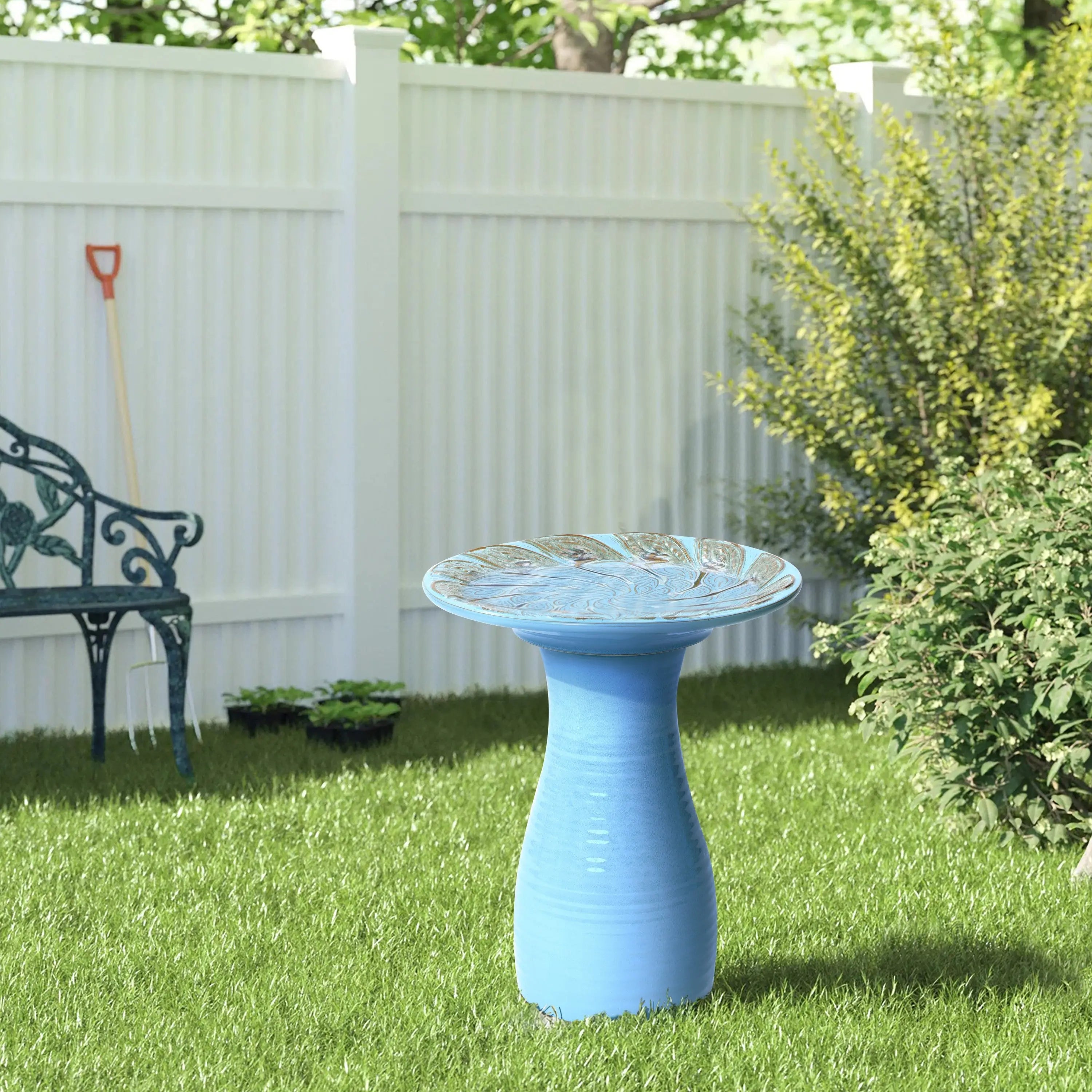 blue bird bath dish top decorated with peacock shaped texture