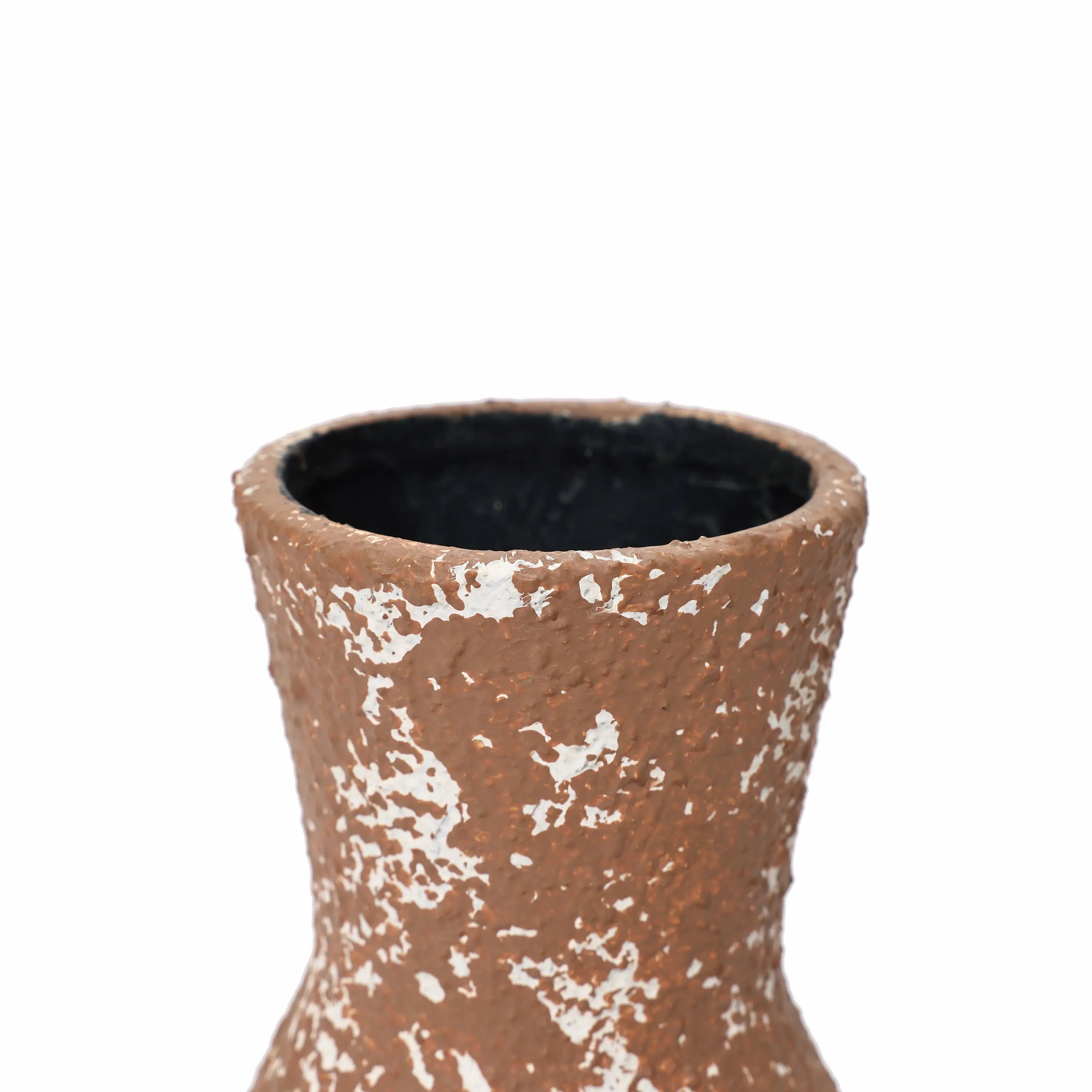 Close-up of the rough textured surface of a tall round ceramic vase with white speckles, exuding rustic charm, showing the upper part and the opening.