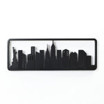 Silhouette of a city skyline, featuring black outlines of buildings against a white background, subtly integrated into a wall-mounted coat rack crafted from solid fir wood with flip-down hooks.