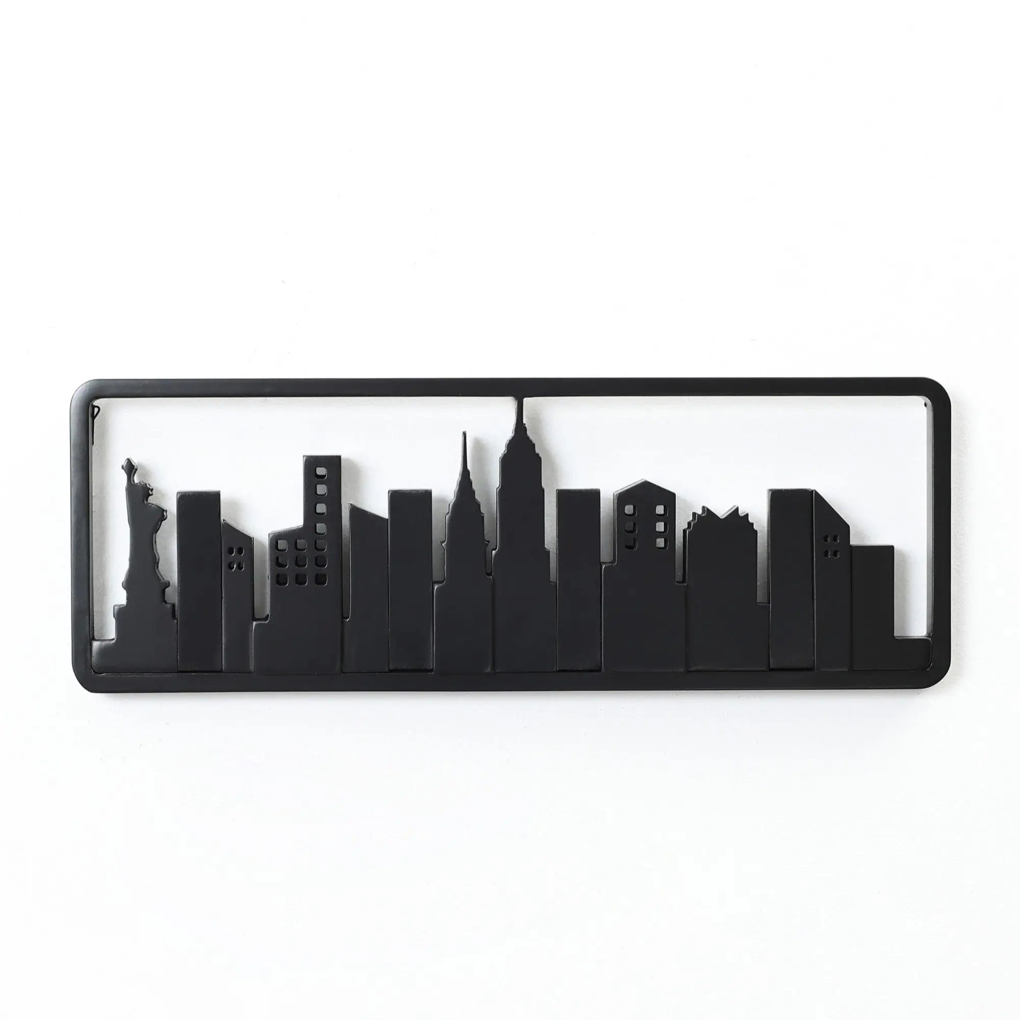 Silhouette of a city skyline, featuring black outlines of buildings against a white background, subtly integrated into a wall-mounted coat rack crafted from solid fir wood with flip-down hooks.