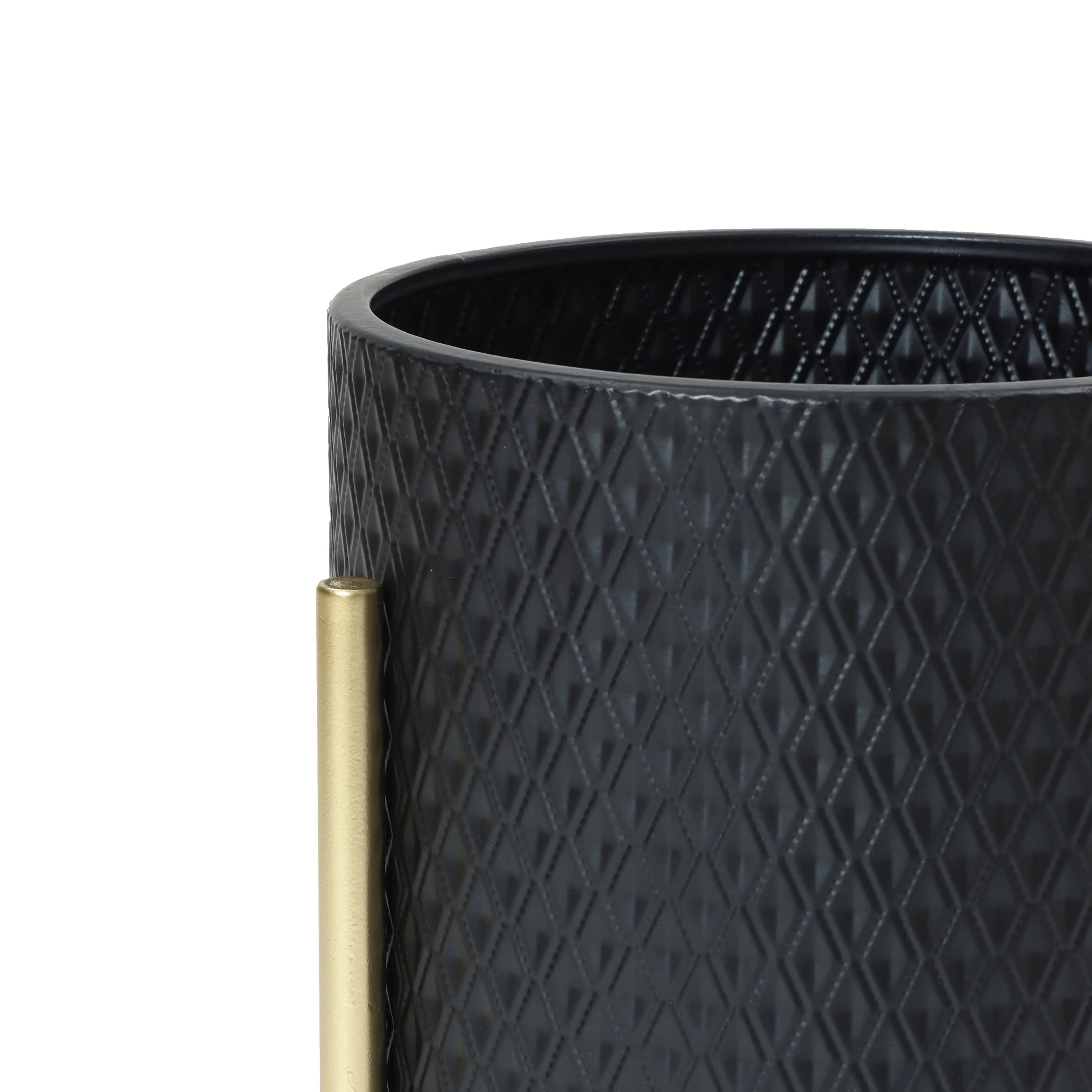 Close-up of a black textured cylindrical container with a diamond pattern, featuring a vertical brass handle on the side. This contemporary modern style planter is perfect for any space, adding both elegance and function to your decor.