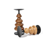 Two birch wood candle holders with black bases, one standing upright and the other lying on its side, add a touch of elegance to your home decor.
