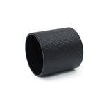 A black cylindrical roller with a textured diamond pattern surface, reminiscent of contemporary modern style planters, is elegantly placed on a white background.