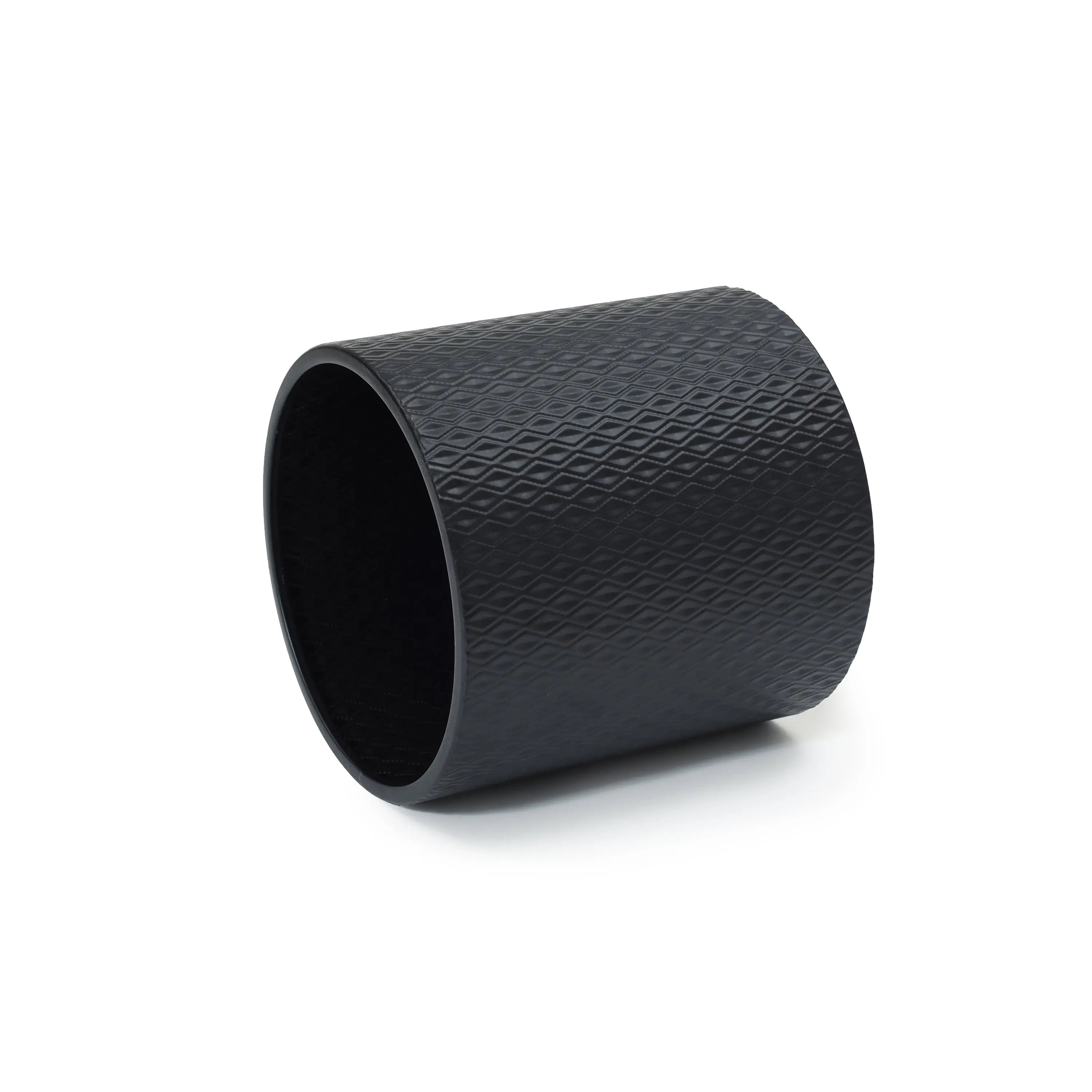 A black cylindrical roller with a textured diamond pattern surface, reminiscent of contemporary modern style planters, is elegantly placed on a white background.