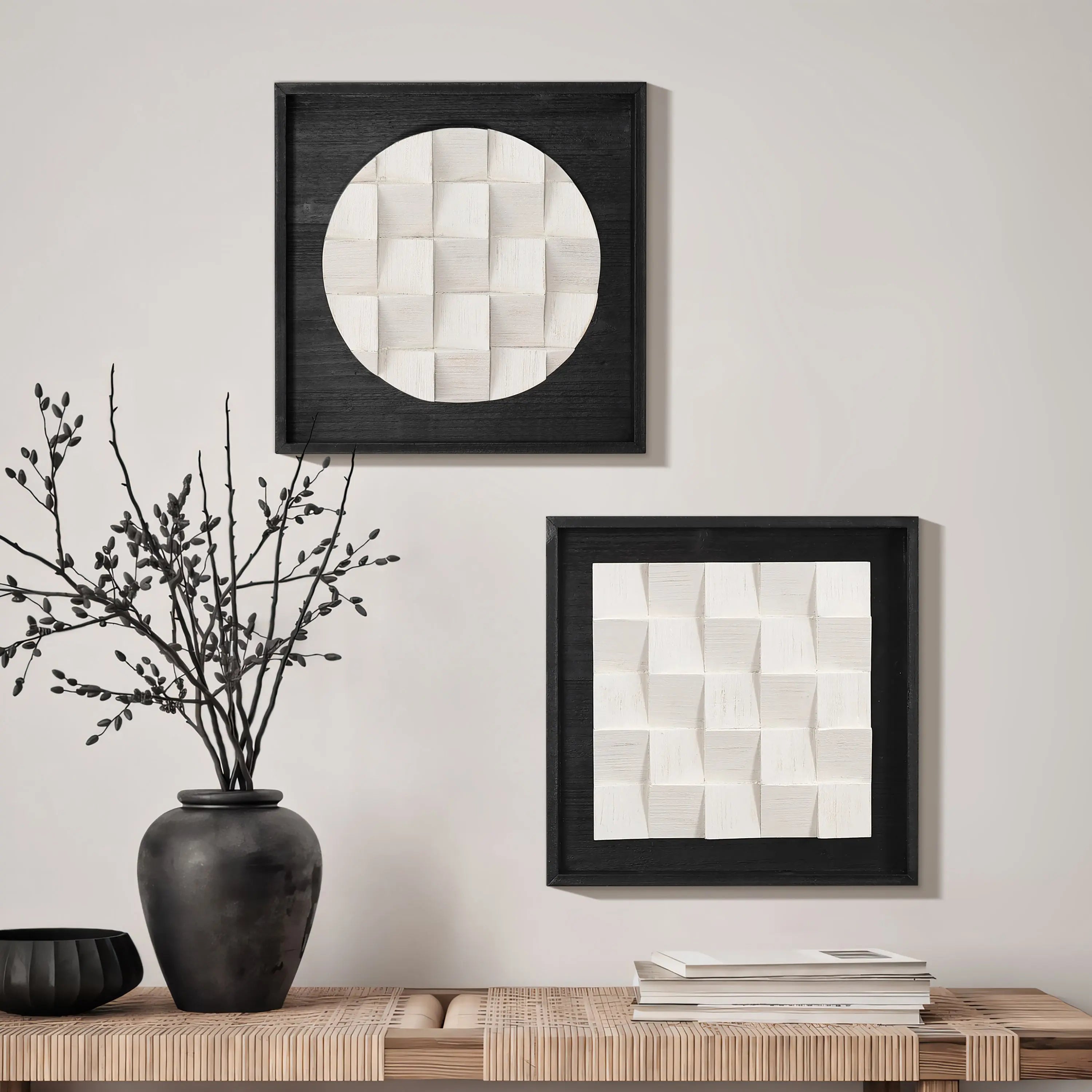 Two framed geometric artworks with a 3D effect bring abstract artistic charm to the wall above a wooden bench, adorned with a black vase and books. These minimalist modern wall hangings effortlessly elevate the space.