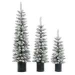 Three flocked artificial trees with PVC branches of varying heights stand side by side in black ribbed pots, bringing a wintry charm to your space. These lifelike Christmas trees are beautifully snow-frosted against a crisp white background.