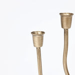 Two brass candle holders with curving stems showcase an elegant design against a plain white background, making them perfect for any home decor.