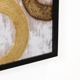 Close-up of a framed painting featuring abstract gold circular patterns on a textured gray backdrop, perfect as sophisticated wall decor.