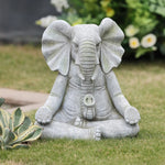 a-stone-elephant-statue-in-a-garden