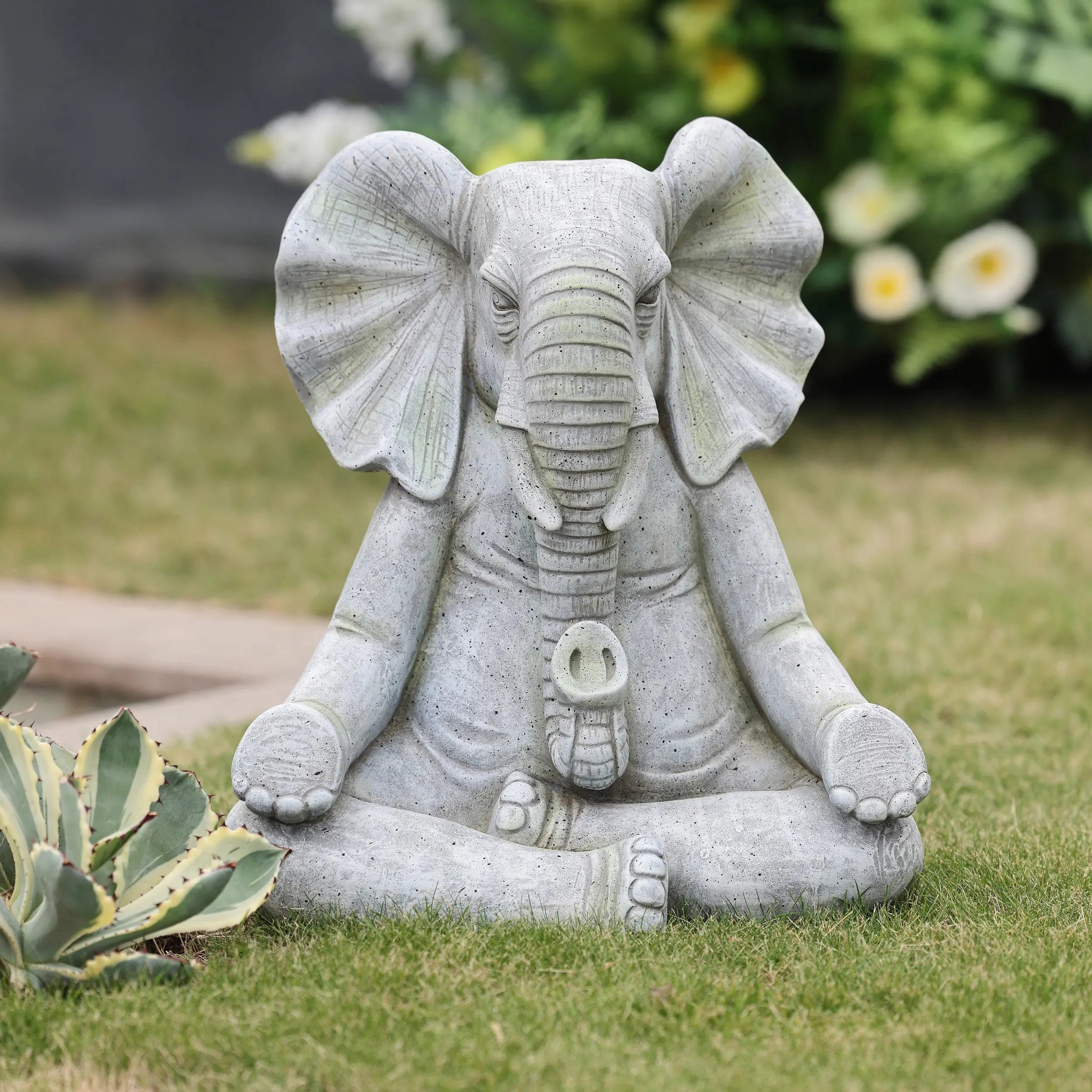 a-stone-elephant-statue-in-a-garden
