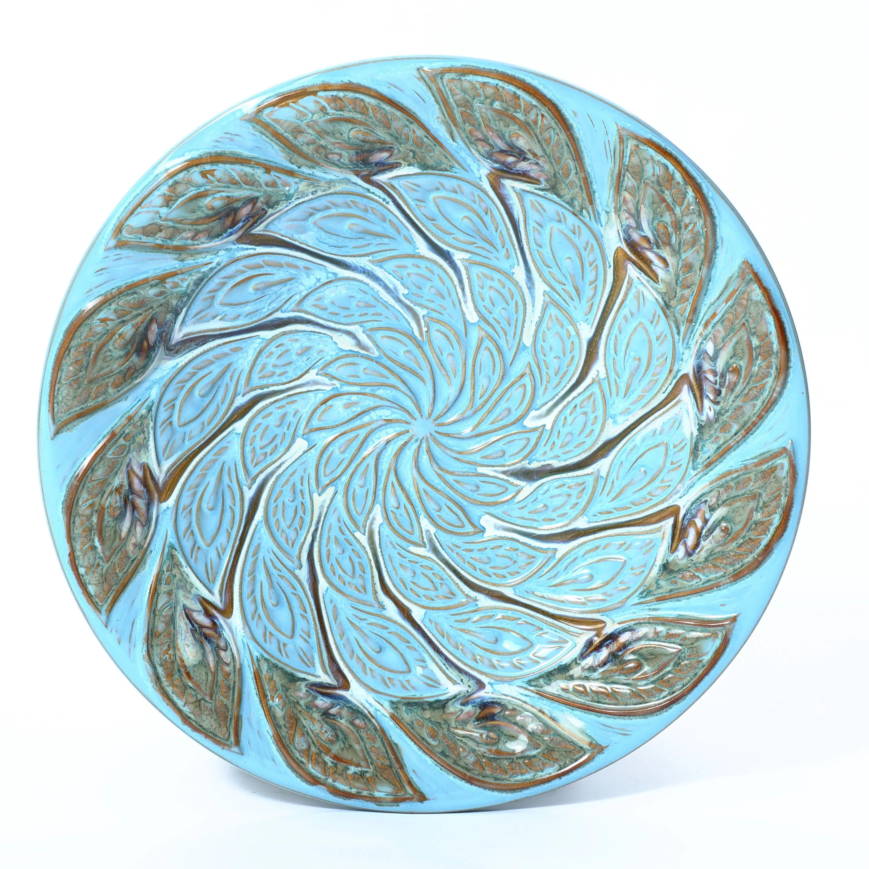 bird bath top has textured pattern like peacock feather