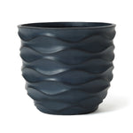 A tall, dark blue pot planter crafted from durable magnesium oxide features a wavy, textured surface that transforms any space into a botanical paradise.